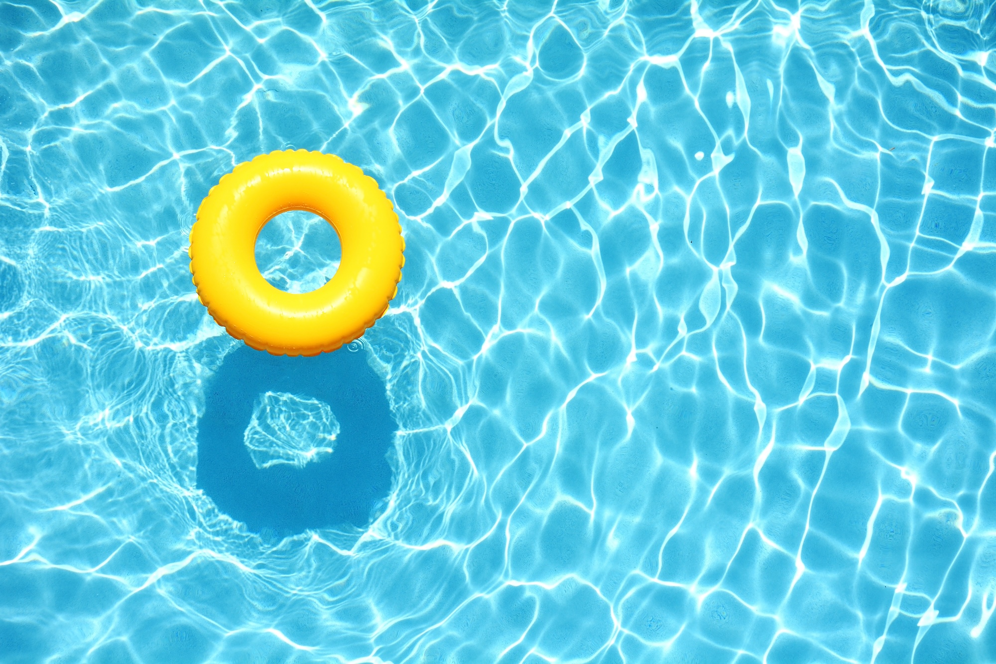 Blue pool with a yellow ring floating